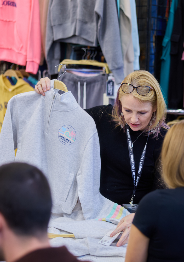 Exhibitor showcases products to fashion buyers at OFFPRICE by Informa
